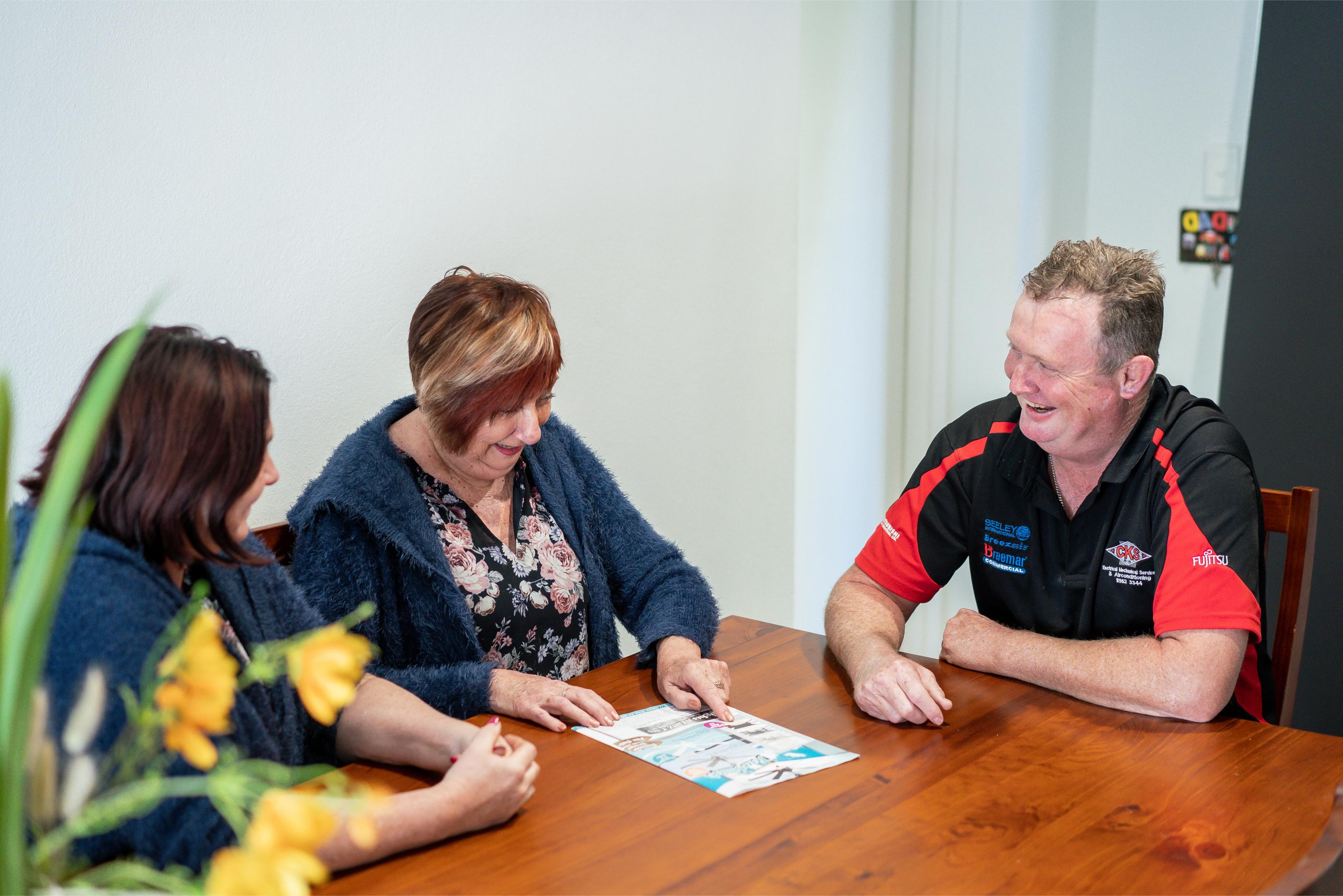 Electrical company staff consulting with customers