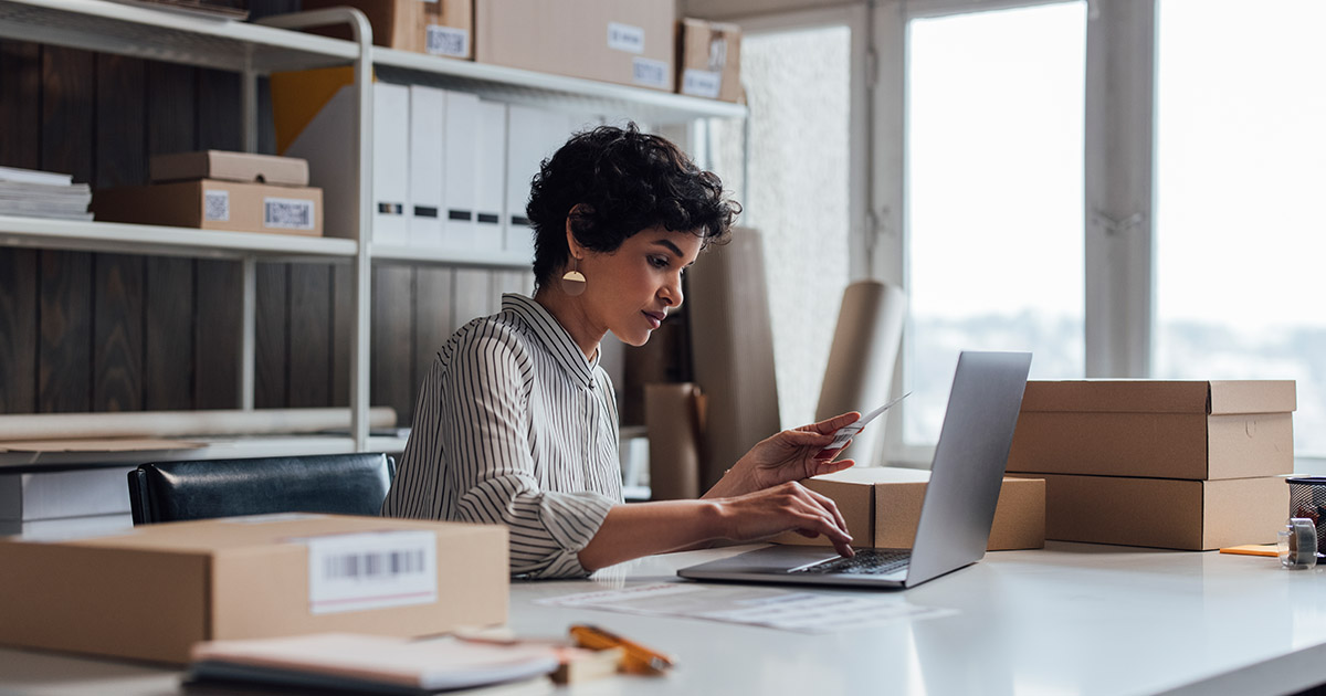  Business owner works on laptop in office.