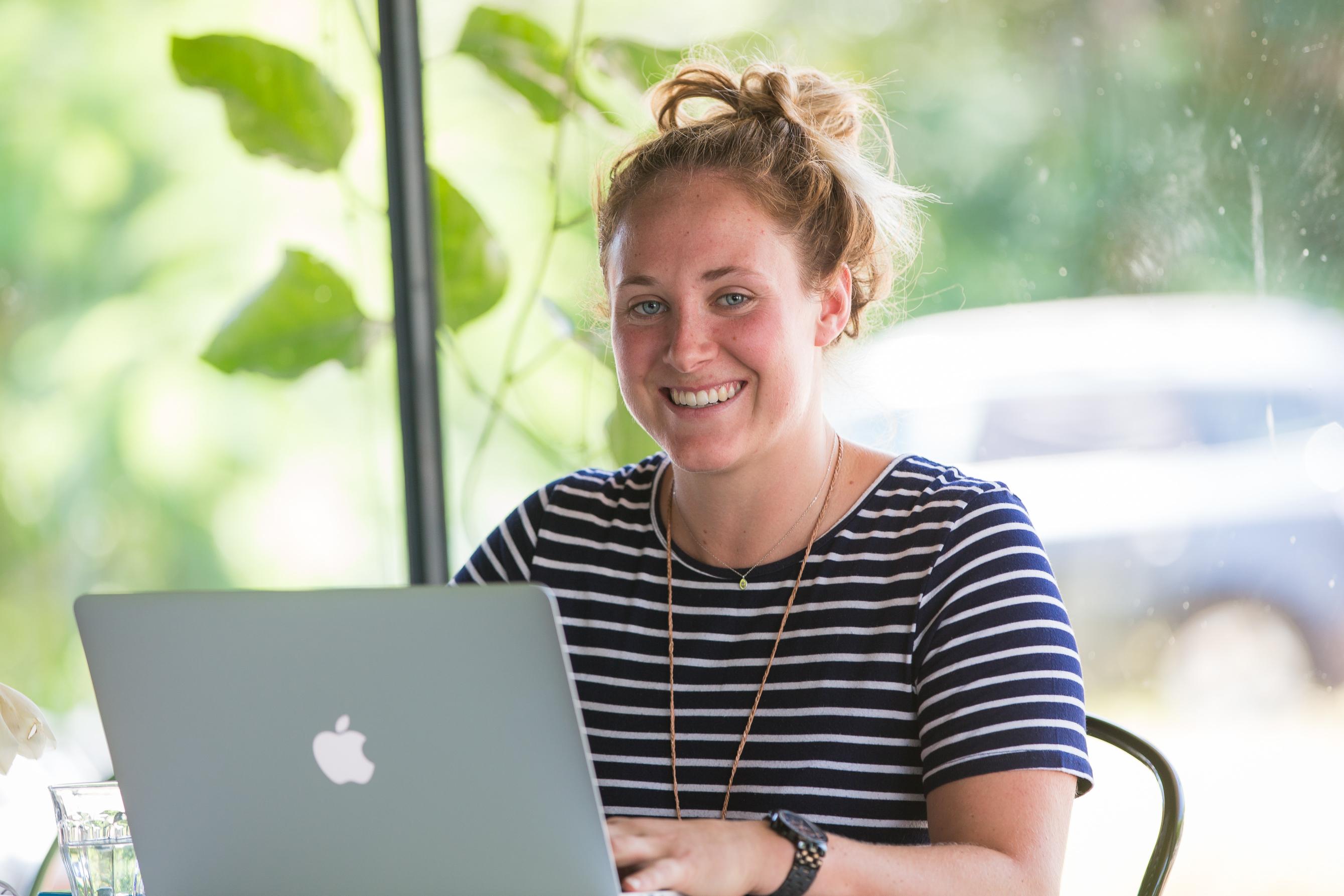 Woman using laptop smiling