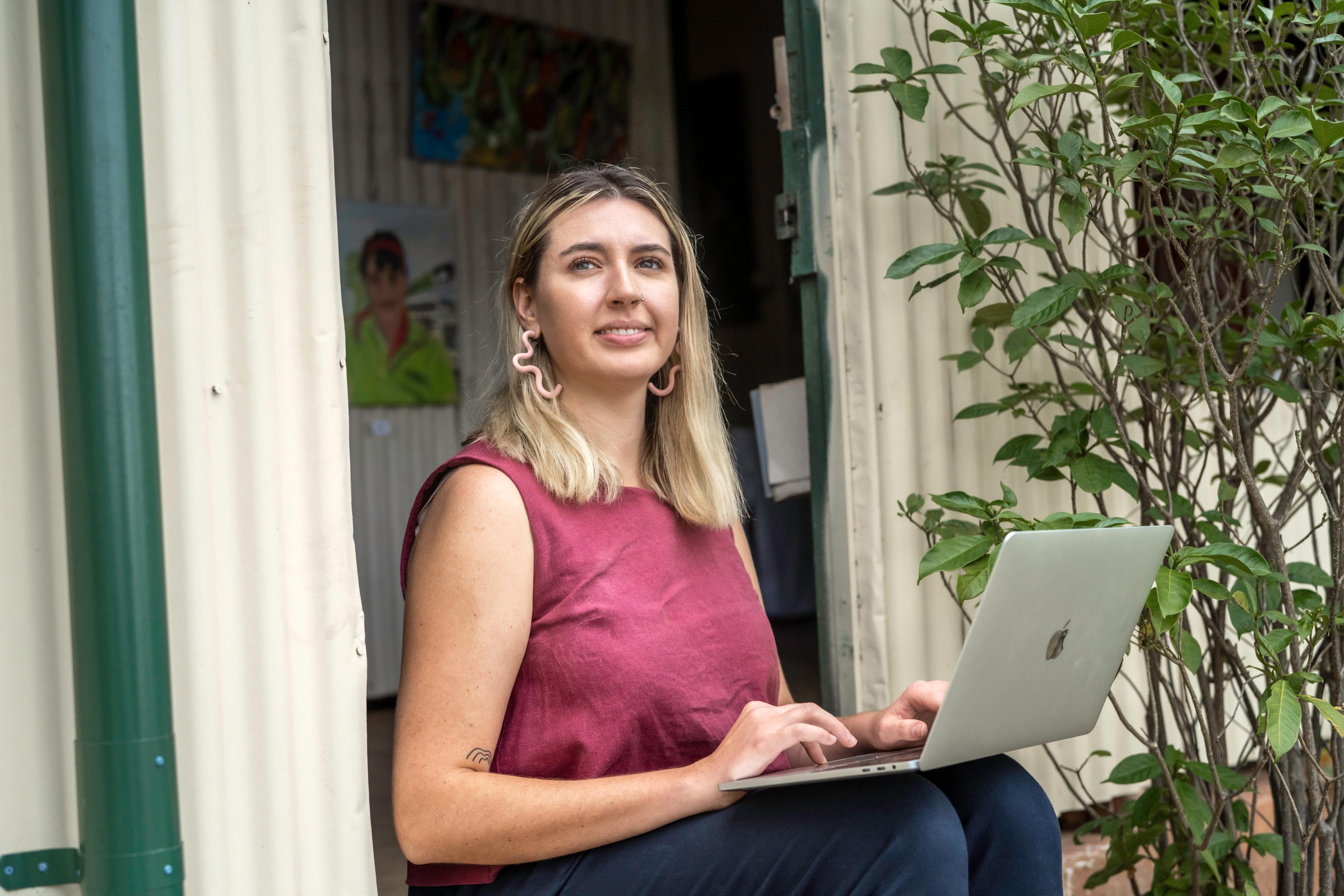 Woman using laptop outside